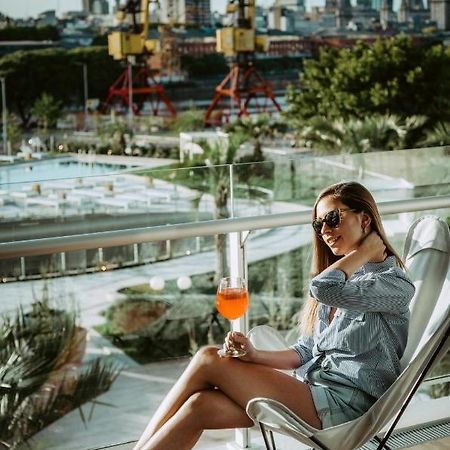 Sls Buenos Aires Puerto Madero 호텔 외부 사진 A woman drinking an Aperol Spritz