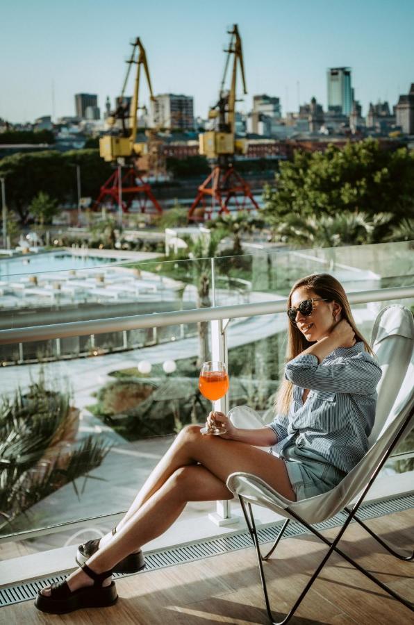 Sls Buenos Aires Puerto Madero 호텔 외부 사진 A woman drinking an Aperol Spritz
